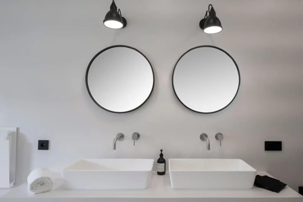 Expert project management in Mallorca: Designer bathroom featuring two sinks and mirrors, showcasing our attention to detail.