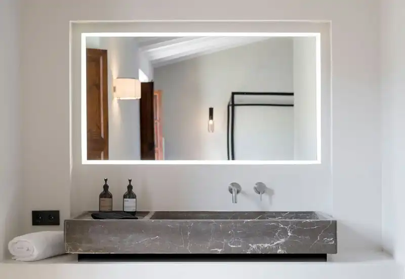 Luxurious design bathroom in Soller, Mallorca: Our project management delivers sophistication, featuring a designer stone sink and luxury taps.