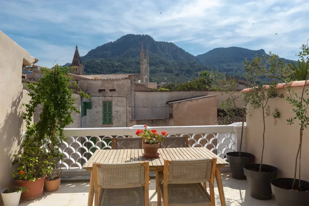 Rooftop terrace with picturesque Mountain and church views.